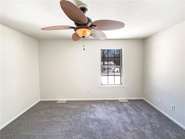 carpeted spare room with visible vents, baseboards, and a textured ceiling