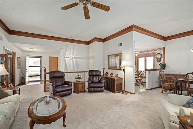 carpeted living room with visible vents, ceiling fan, baseboards, ornamental molding, and a textured ceiling