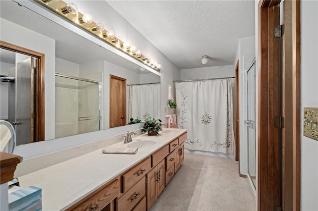 full bath featuring curtained shower, a textured ceiling, and vanity