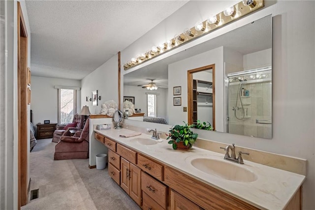 ensuite bathroom with a sink, a stall shower, and ensuite bathroom