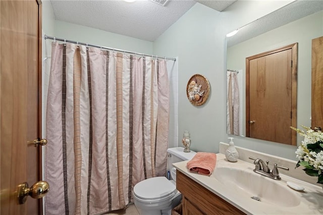 bathroom featuring toilet, a textured ceiling, and vanity