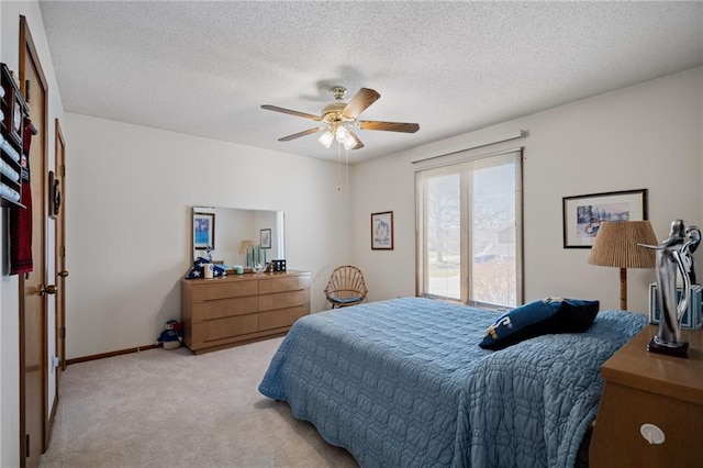 bedroom with baseboards, light colored carpet, a textured ceiling, and ceiling fan