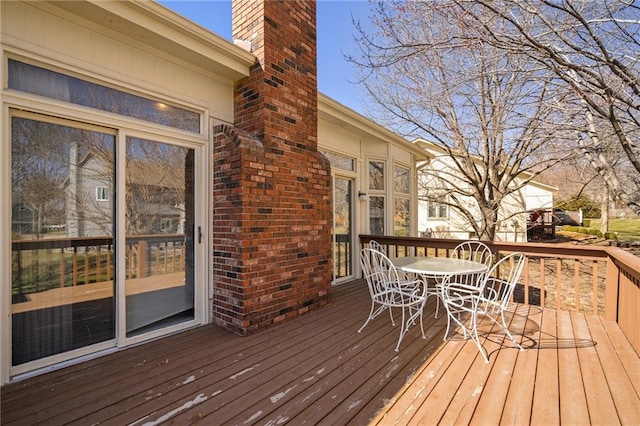 wooden deck featuring outdoor dining space