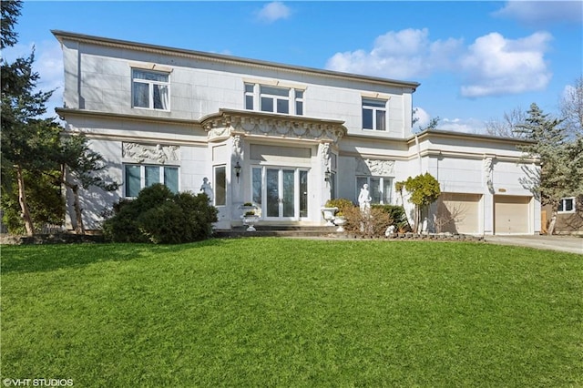 view of front of property featuring french doors, an attached garage, driveway, and a front yard