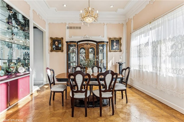 dining room with a notable chandelier, baseboards, visible vents, and ornamental molding