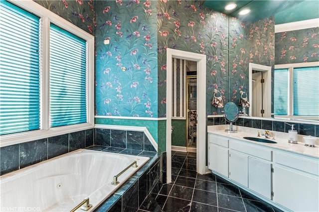 full bath featuring tile patterned floors, a whirlpool tub, vanity, and wallpapered walls