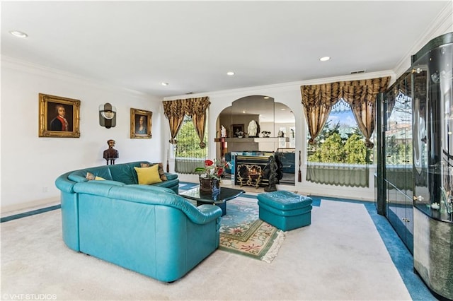 living room with recessed lighting, a healthy amount of sunlight, and crown molding