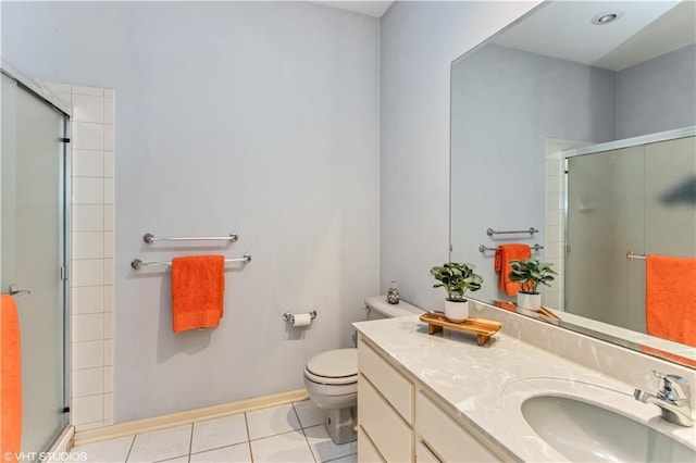 bathroom with tile patterned flooring, toilet, vanity, and a shower with door