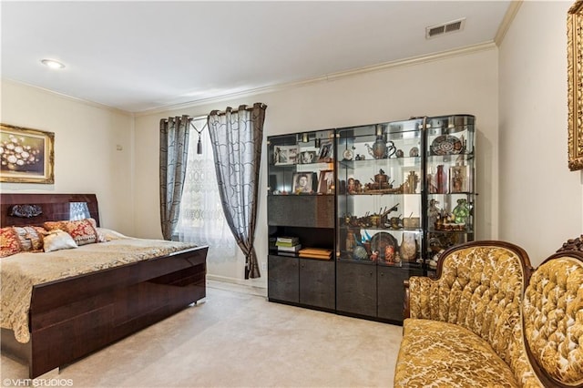 carpeted bedroom featuring crown molding and visible vents