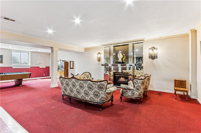 living area with carpet, visible vents, baseboards, a fireplace, and crown molding