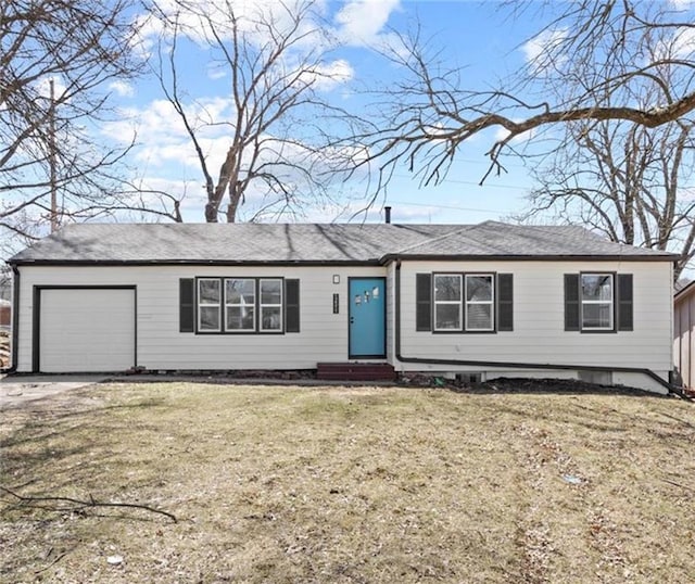 ranch-style house featuring a front lawn, an attached garage, and entry steps