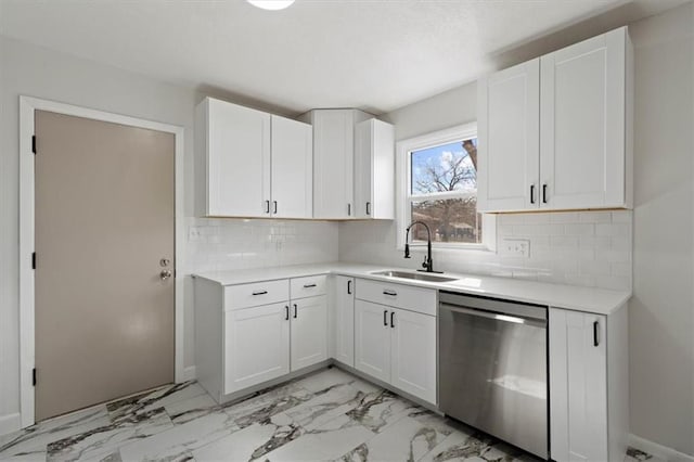 kitchen featuring white cabinetry, a sink, light countertops, dishwasher, and backsplash