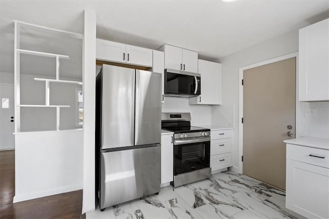 kitchen featuring marble finish floor, white cabinets, appliances with stainless steel finishes, and light countertops