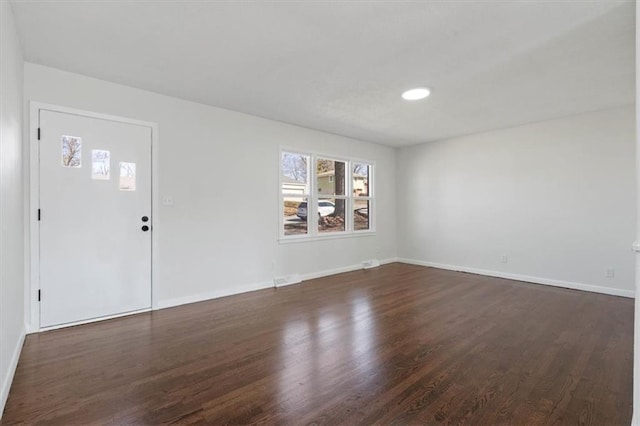 interior space with dark wood-type flooring and baseboards