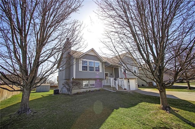 view of front facade with a front lawn, fence, a chimney, a garage, and driveway