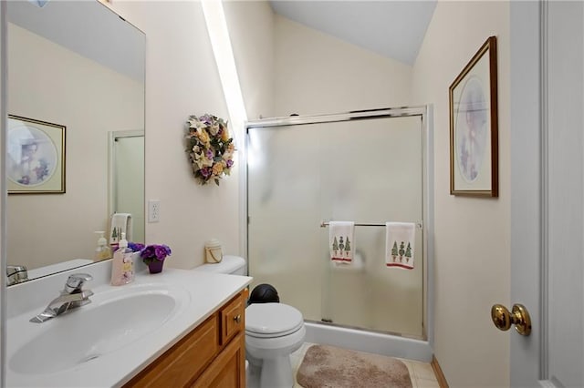 bathroom with tile patterned floors, toilet, a stall shower, vanity, and vaulted ceiling