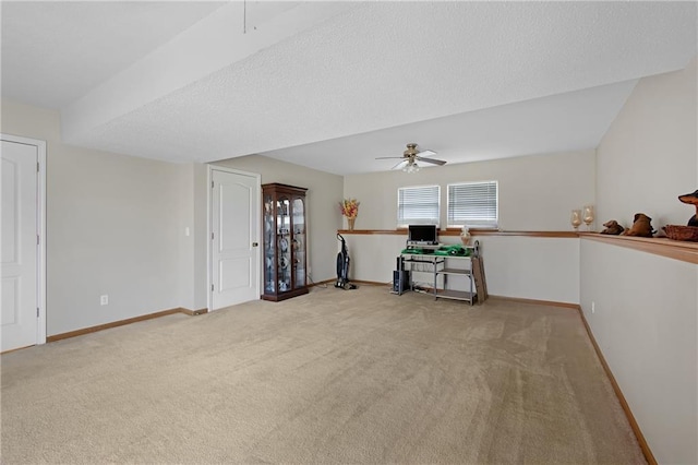 carpeted empty room with baseboards, a textured ceiling, and a ceiling fan