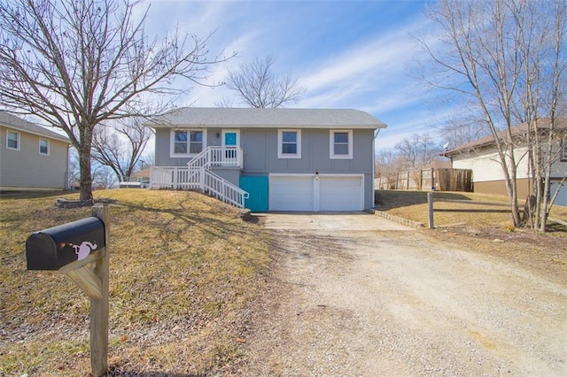 view of front of house featuring a front yard, a garage, board and batten siding, and driveway