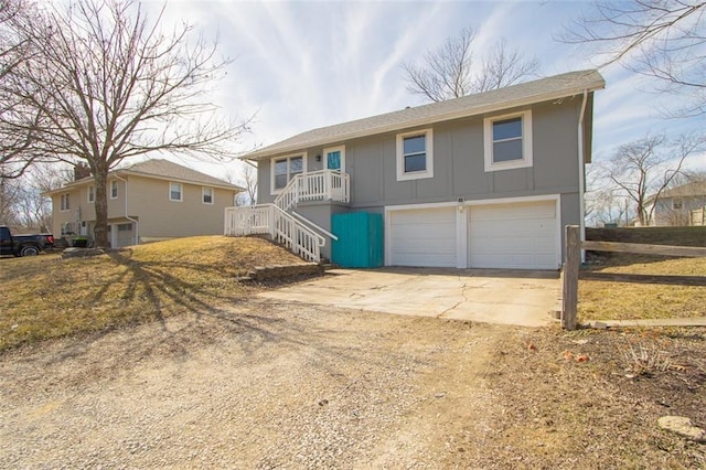 view of front facade featuring board and batten siding, fence, stairway, concrete driveway, and a garage