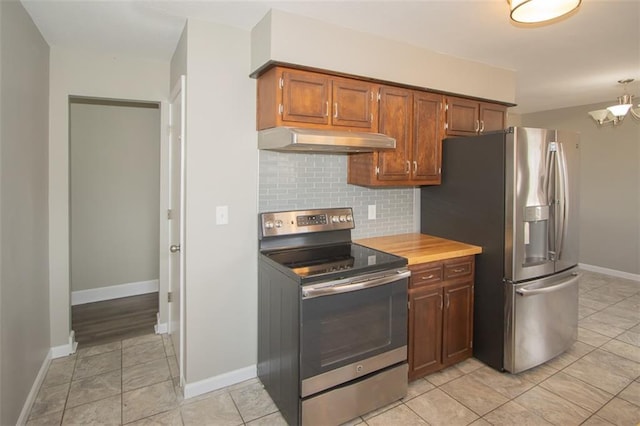 kitchen with baseboards, stainless steel appliances, light countertops, under cabinet range hood, and backsplash