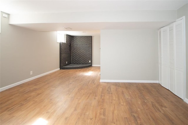 interior space with baseboards and light wood finished floors