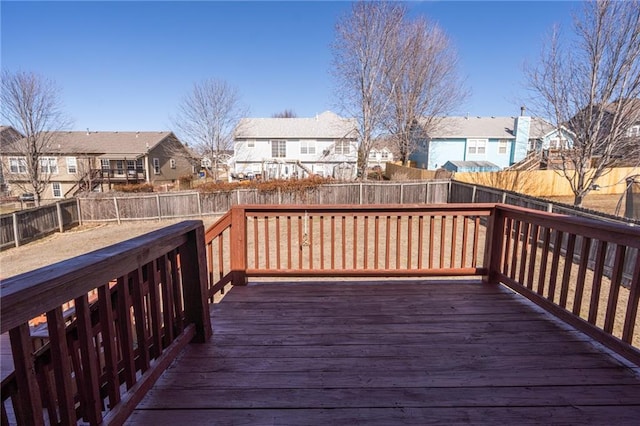 wooden terrace featuring a residential view and a fenced backyard