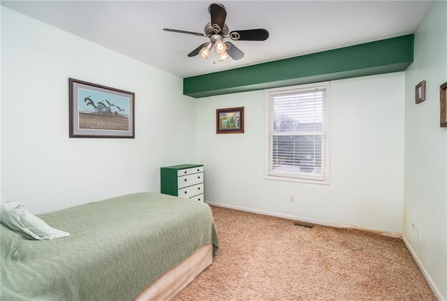 carpeted bedroom featuring baseboards, visible vents, and ceiling fan