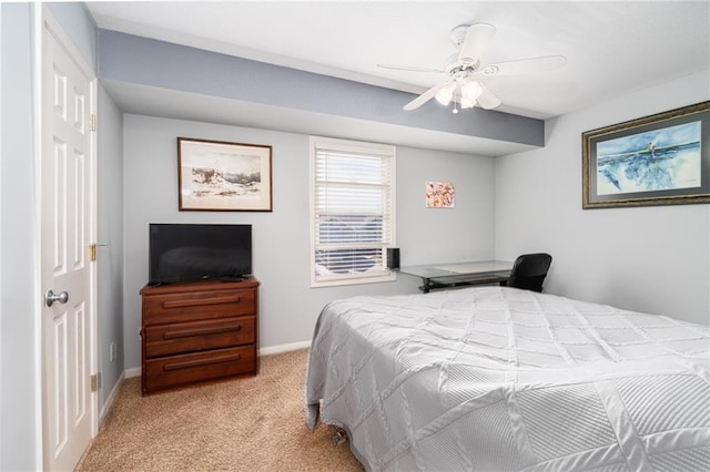 bedroom with light colored carpet, baseboards, and ceiling fan