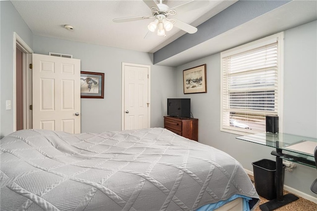 bedroom with visible vents, baseboards, and a ceiling fan