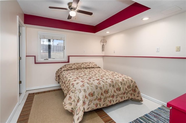 bedroom with a ceiling fan, a raised ceiling, recessed lighting, and baseboards