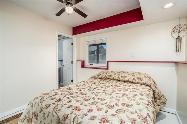 bedroom with a ceiling fan and baseboards