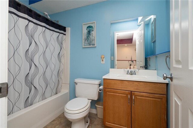 full bathroom with tile patterned floors, toilet, vanity, and shower / bath combination with curtain