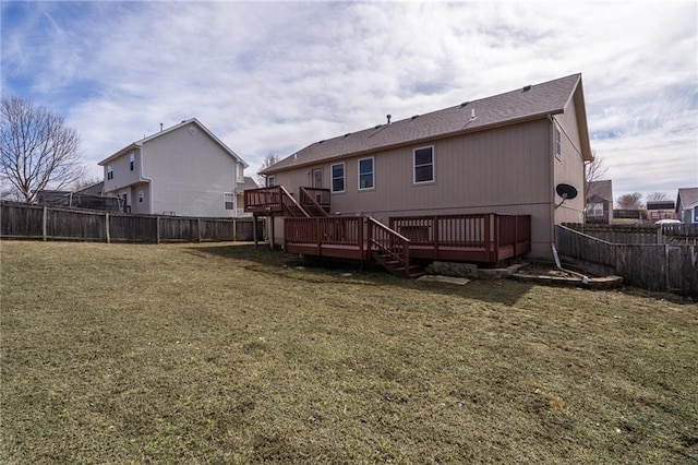 back of house with a deck, a yard, and a fenced backyard