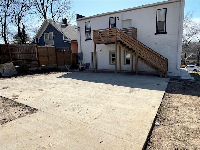 back of property with stairway and fence