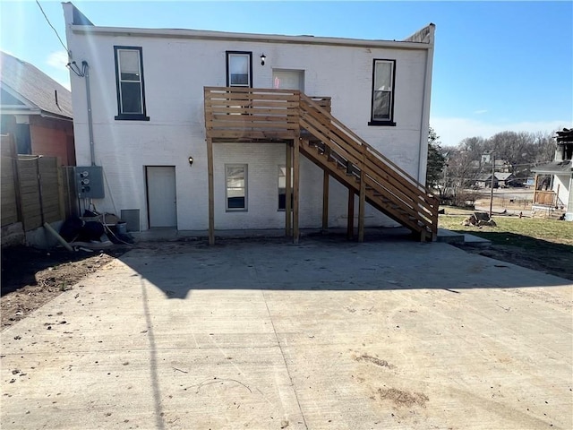 rear view of property with stairway