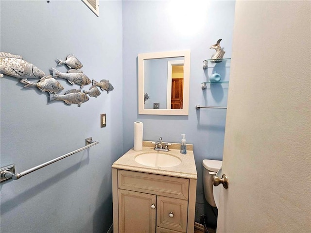 bathroom with toilet and vanity