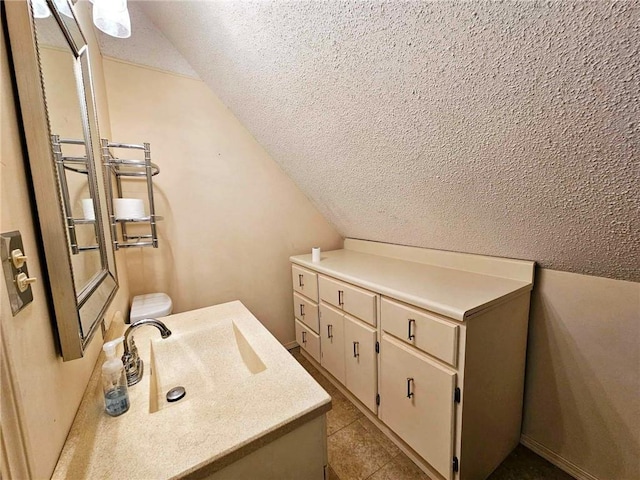 bathroom featuring tile patterned flooring, a textured ceiling, and lofted ceiling