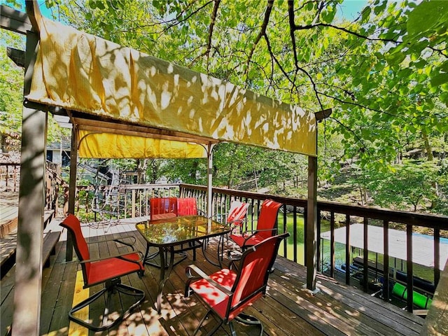 wooden deck featuring outdoor dining area