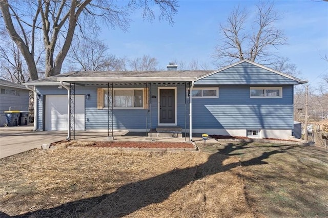 ranch-style home with concrete driveway and a garage