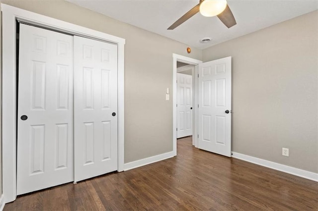 unfurnished bedroom featuring visible vents, a ceiling fan, dark wood finished floors, a closet, and baseboards