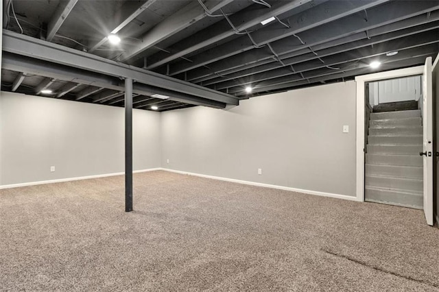 finished basement with stairway, carpet, and baseboards