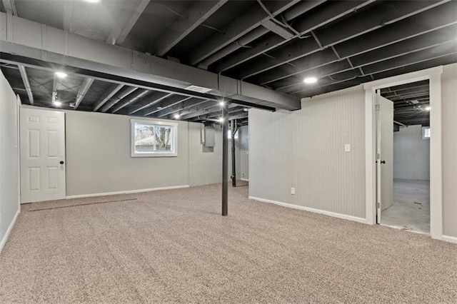 below grade area with baseboards and carpet floors