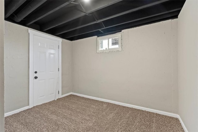 basement featuring baseboards and carpet floors