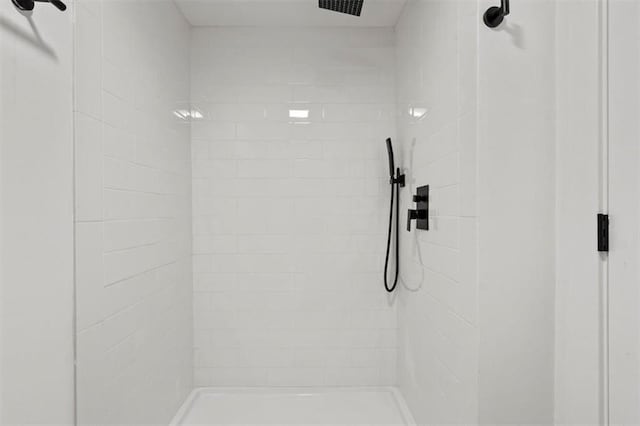 bathroom with tiled shower