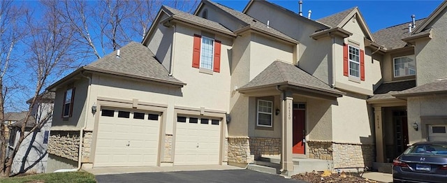 view of front of property with aphalt driveway, stone siding, roof with shingles, and stucco siding