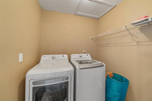 laundry room with laundry area, attic access, and separate washer and dryer