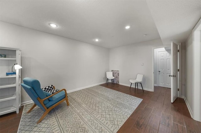 sitting room with recessed lighting, wood finished floors, baseboards, and a textured ceiling