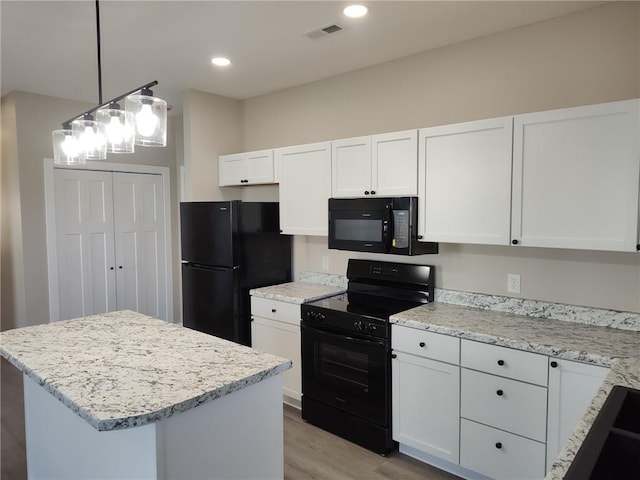 kitchen with visible vents, black appliances, decorative light fixtures, white cabinets, and light stone countertops