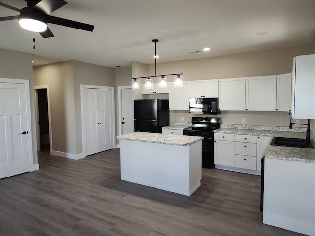 kitchen featuring black appliances, a kitchen island, dark wood finished floors, white cabinetry, and a sink