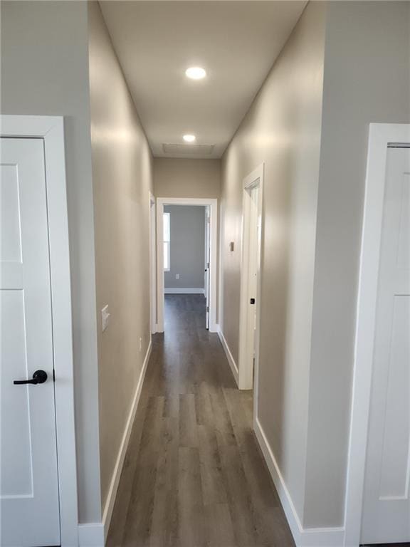 hall with dark wood-style floors, recessed lighting, and baseboards